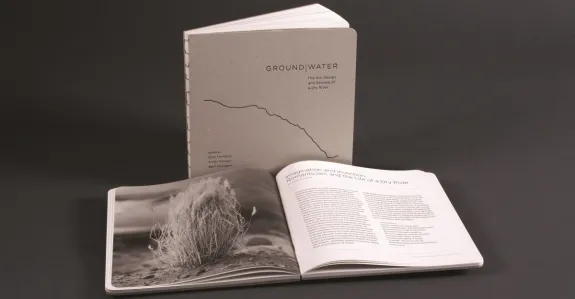 a greyscale picture of a book and another open book in front of it